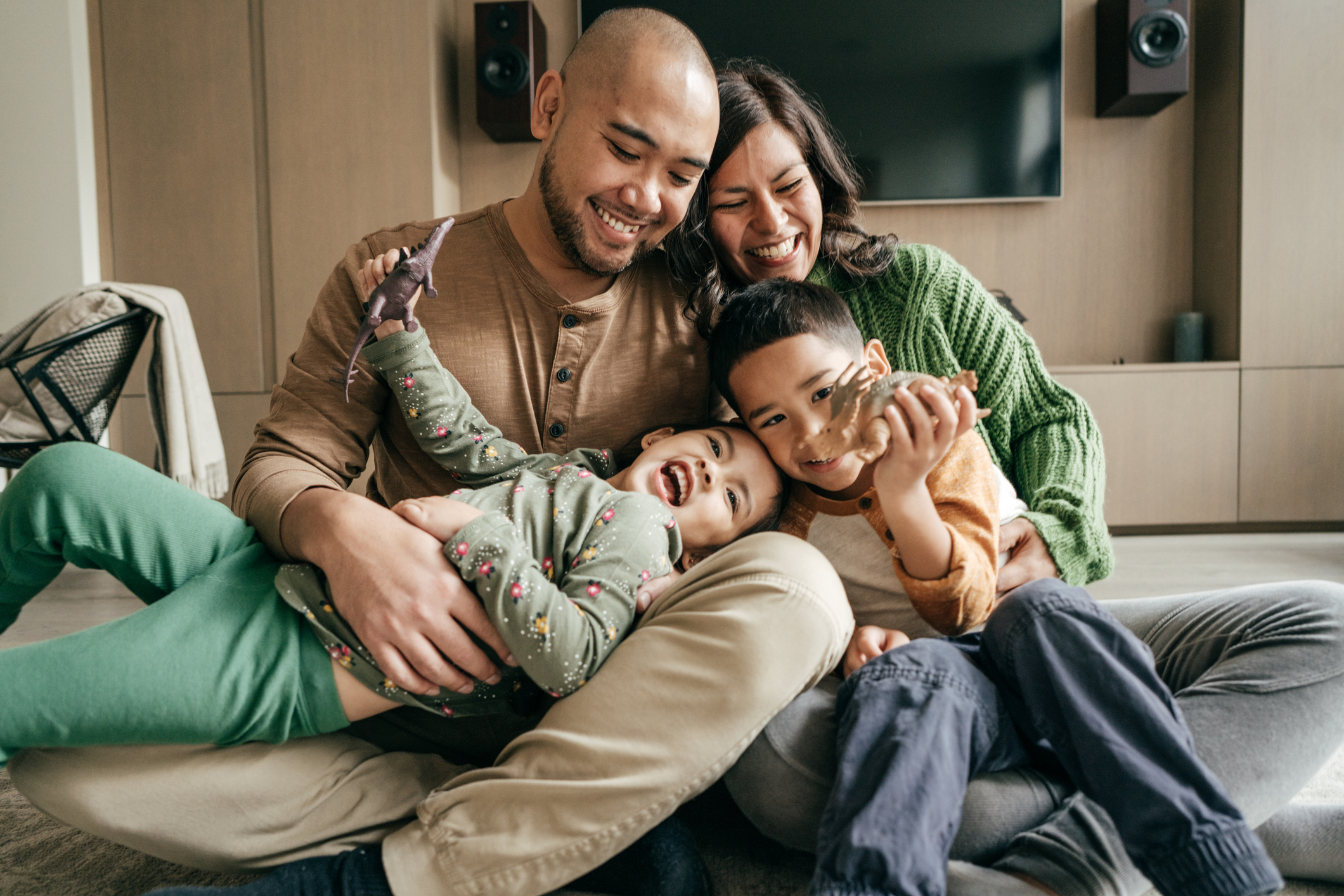 Family with two kids Photo of parents holding happy children